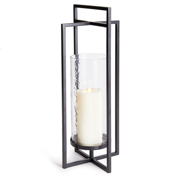 A black, geometric-designed iron and glass lantern with a candle inside, featuring a minimalist and contemporary style.