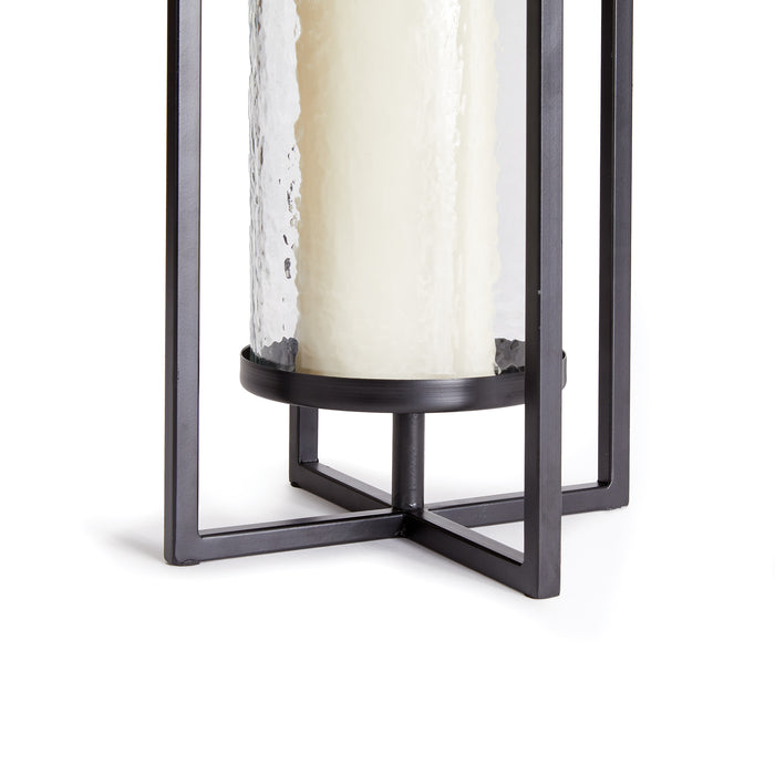Large lantern with cylindrical frosted glass inside a black metal frame, visible base and corner supports.