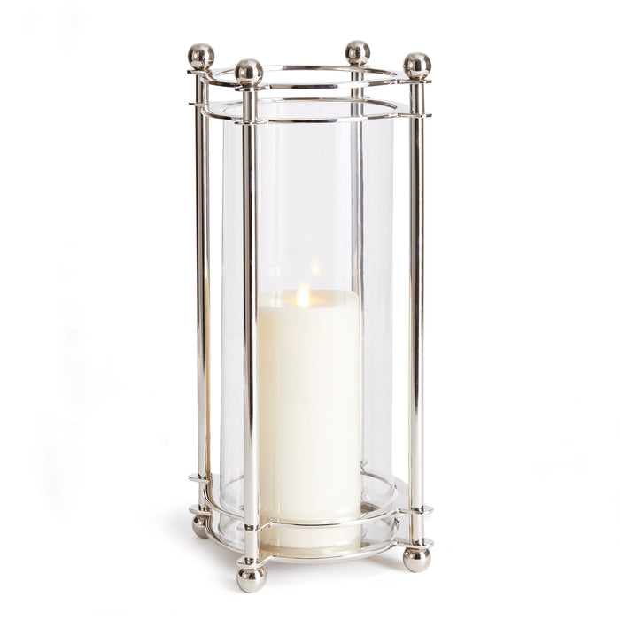 A cylindrical glass hurricane with a shiny chrome finish, featuring a closed bottom and a lit candle inside, designed for indoor use.