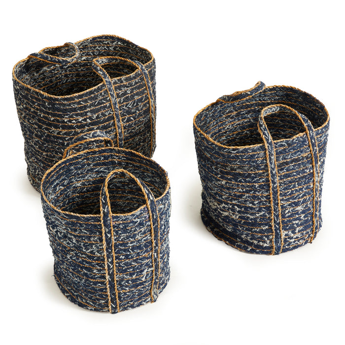 Three round denim baskets in dark blue with tan rope trim, varying heights, woven texture, against a white background