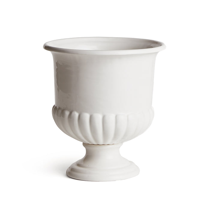 White ceramic decorative pedestal bowl with fluted base and wide rim on a short stand, plain background.
