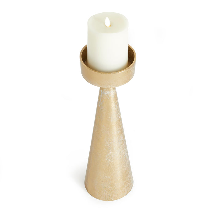 Gold-toned metal candle stand with a tapered conical base and a circular holder holding a white pillar candle.