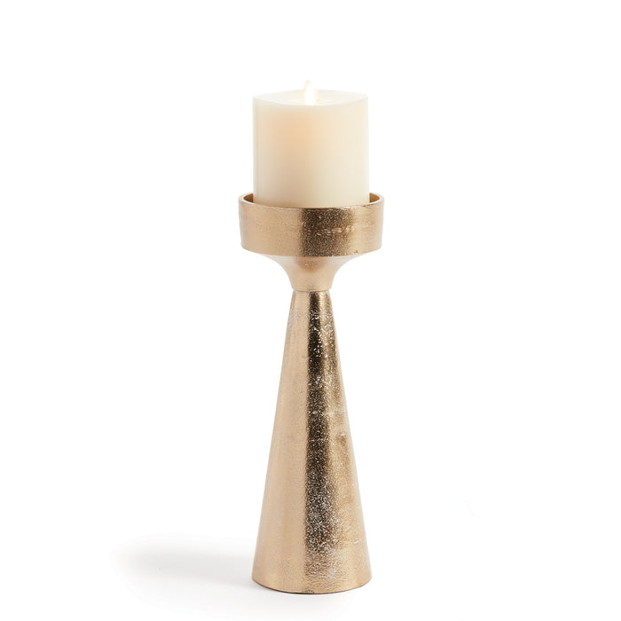 A gold-colored aluminum candle stand with a cylindrical base and a rolled edge, featuring a white ash wash finish and a candle placed on top.