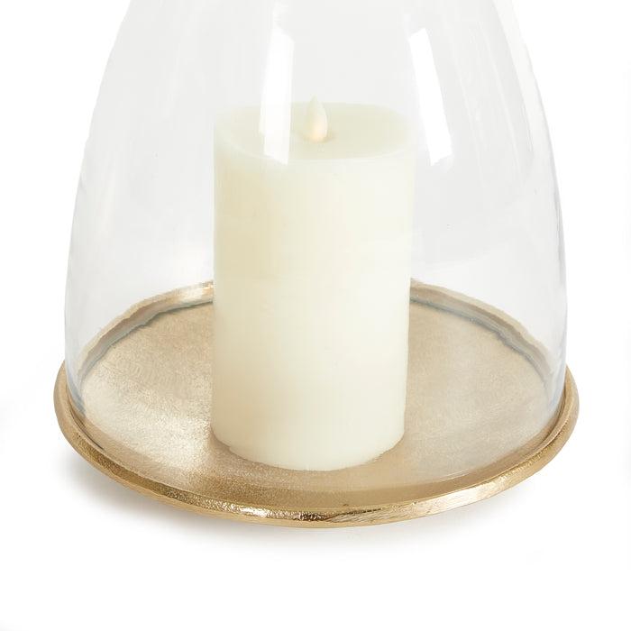 Ivory pillar candle on a gold-toned round base under a glass cloche.