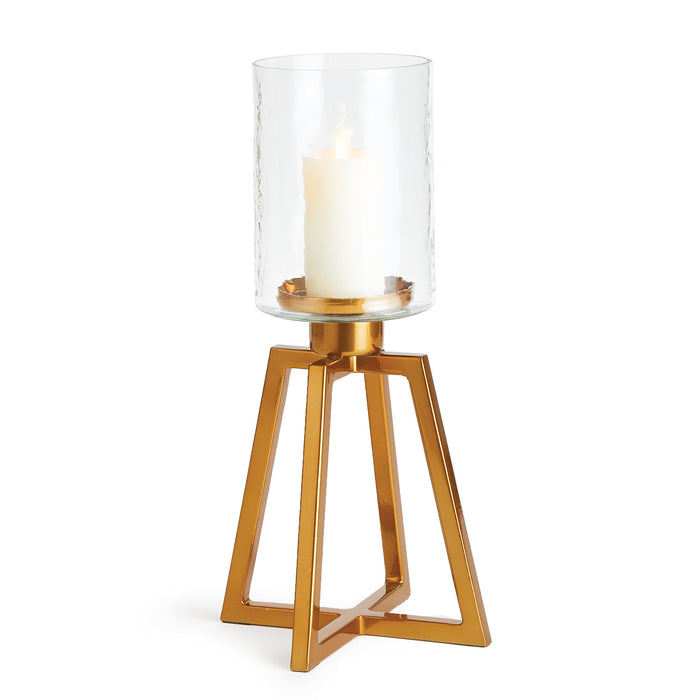 A tall, tapered metal base with a hammered glass hurricane holding a candle, set against a white background.