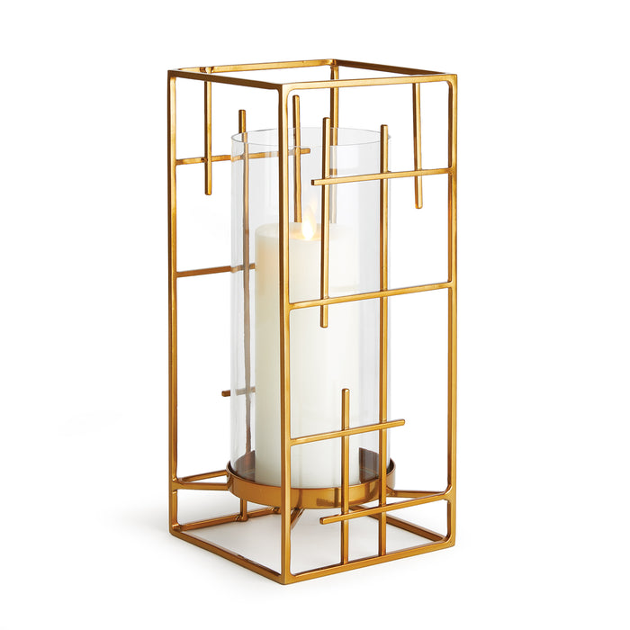 A gold-colored geometric-patterned metal hurricane candle holder with a clear glass candle holder inserted.