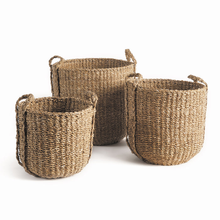 A set of three round seagrass drum baskets with woven handles.