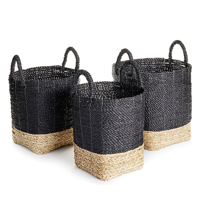 A set of three black and beige wicker market baskets with handles.