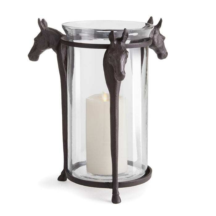 A hurricane-style candle holder with a cast aluminum base and glass body, featuring horse-shaped details on the base.