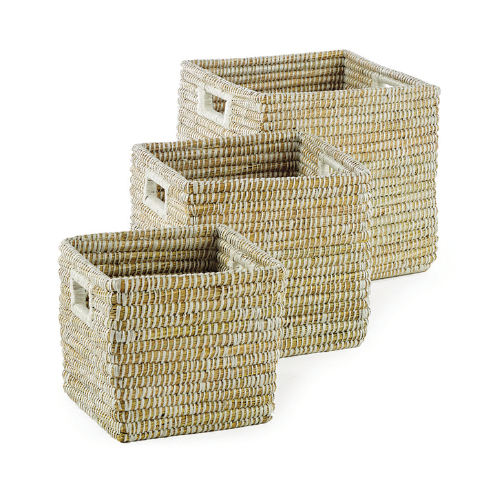 A set of three square wicker baskets with handles, featuring a natural rivergrass color and weave.