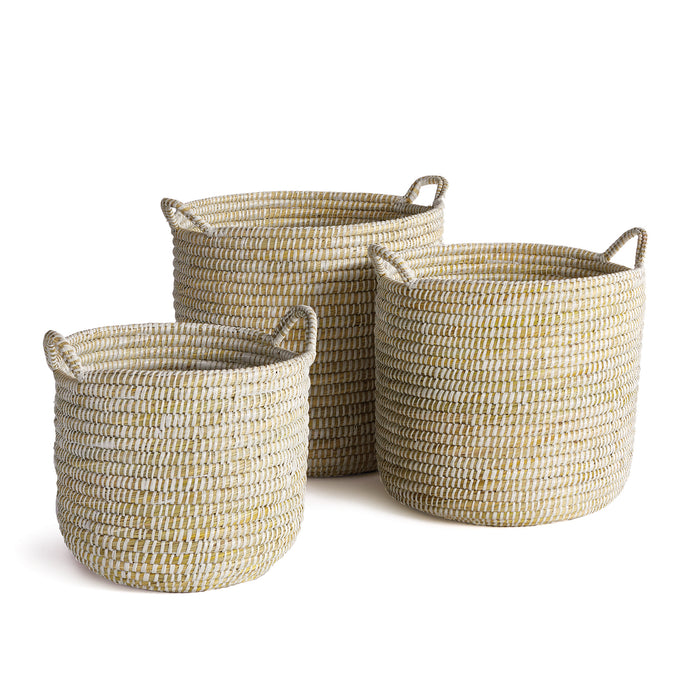 A set of three round, beige wicker baskets with handles.