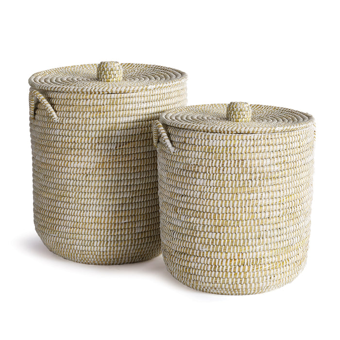 A set of two beige hand-woven rivergrass hamper baskets with lids.