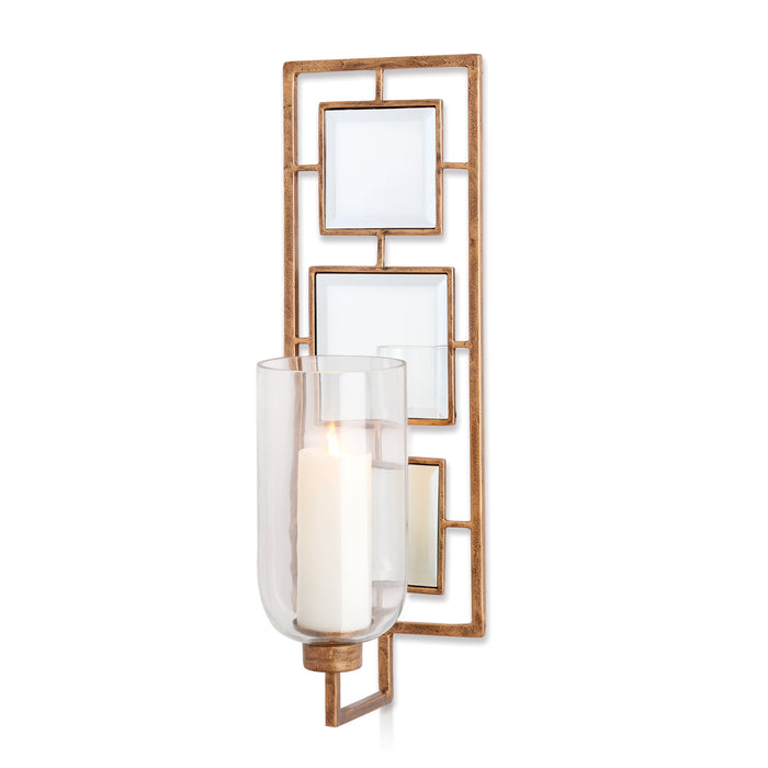 A wall-mounted candle sconce with antique gold finish, mirrors, and glass panels.