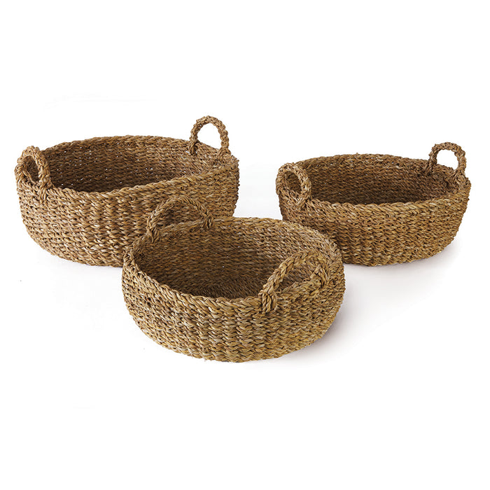 A set of three round seagrass shallow baskets with handles.