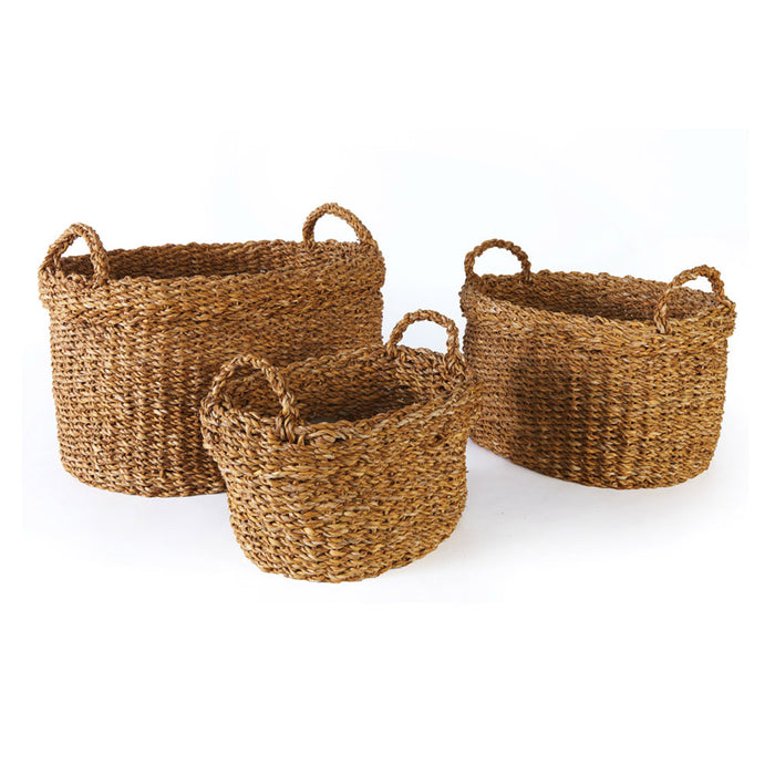 A set of three oval-shaped seagrass baskets with handles, displayed against a white background.