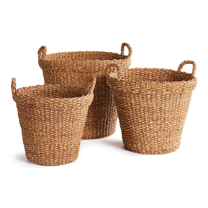 A set of three tapered, round seagrass baskets with handles, displayed against a white background.