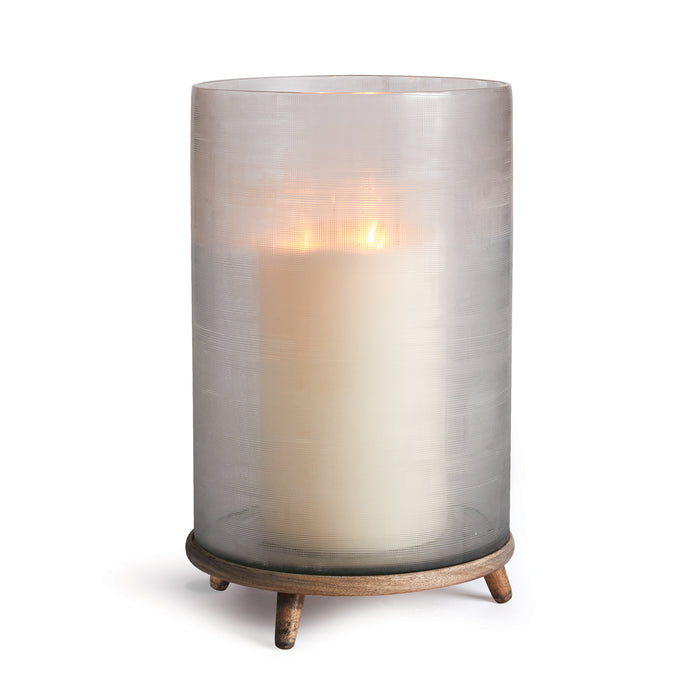 A clear glass candle holder with a linen-inspired texture and a natural wood tone base.