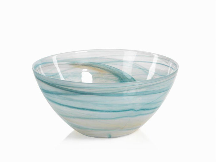 Glass bowl with blue and white swirl pattern on a white background
