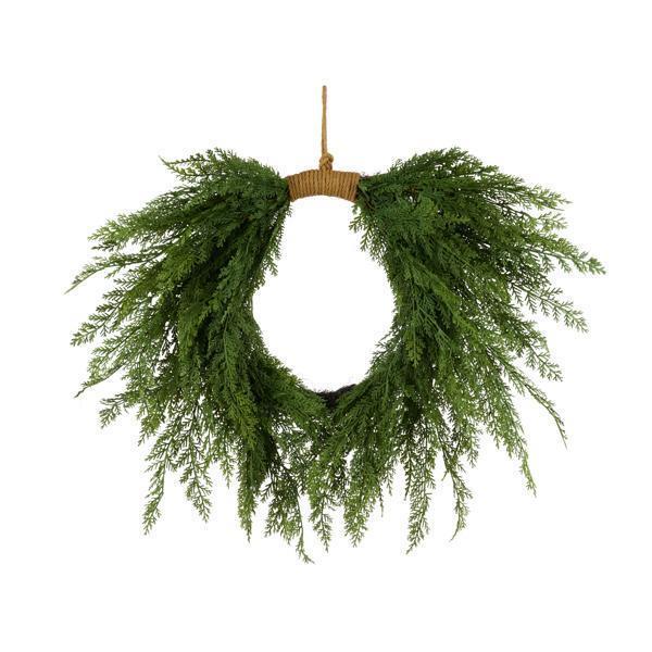 Green wreath with a wooden ring on a white background