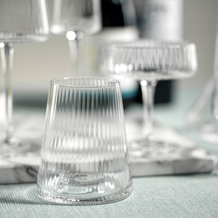 Clear glass tumbler on a marble surface with blurred background