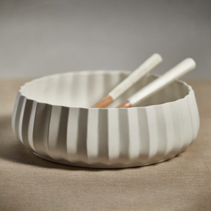 Ceramic bowl with striped pattern on a beige surface