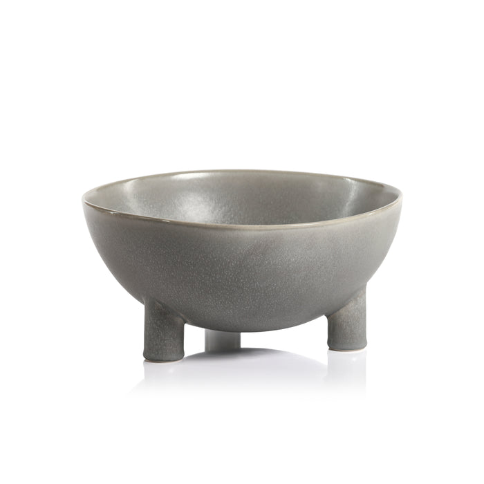Gray ceramic bowl with three small legs on a white background