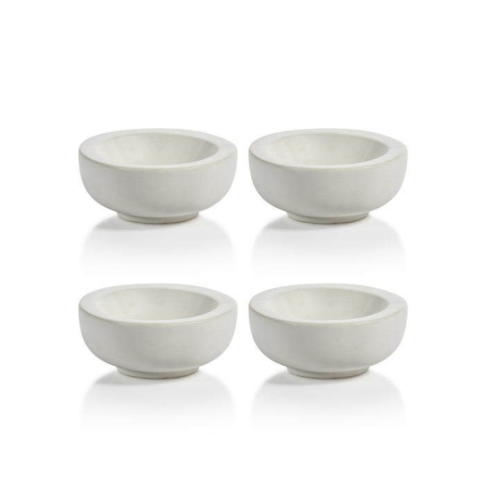 Set of four small white ceramic bowls on a white background