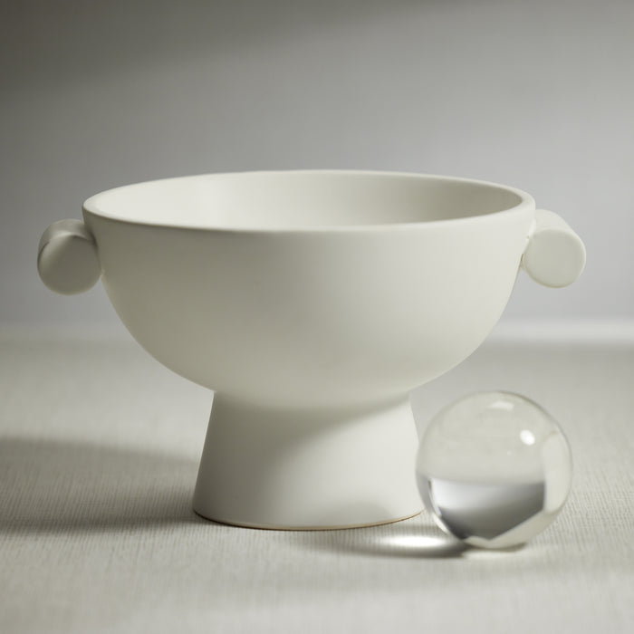 White ceramic bowl with handles on a light gray background