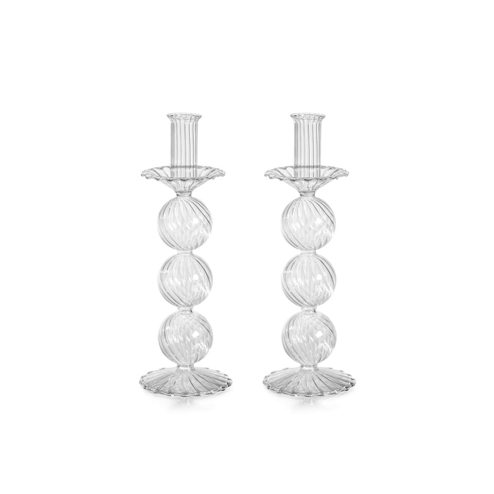 Two clear glass candle holders on a white background
