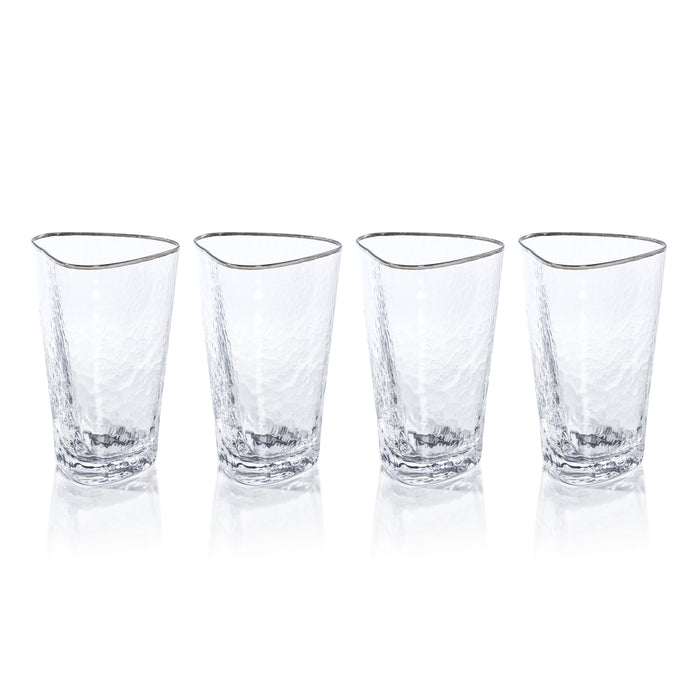 Four clear glass tumblers with gold rims on a white background