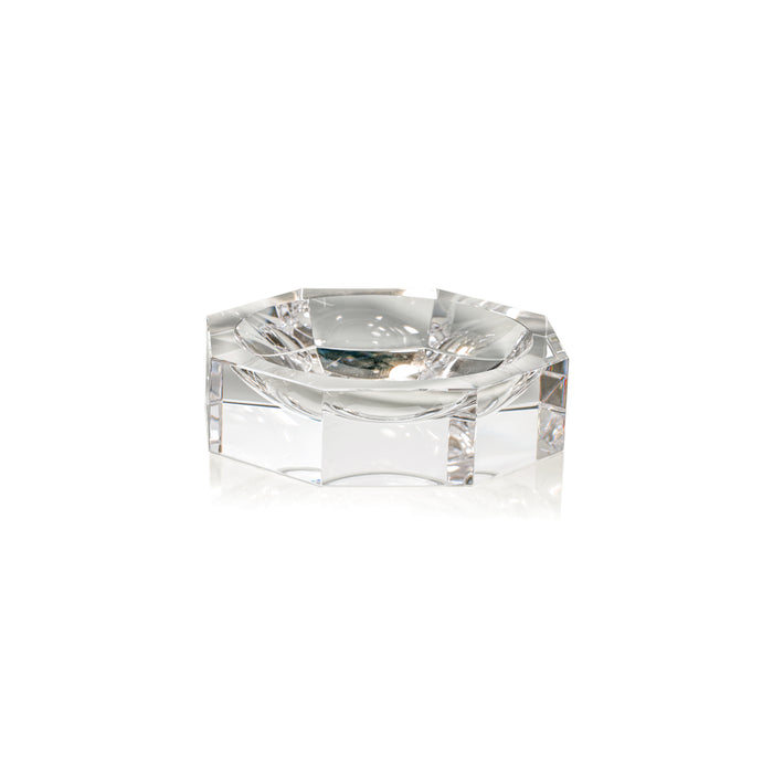 Clear glass hexagonal candle holder on a white background