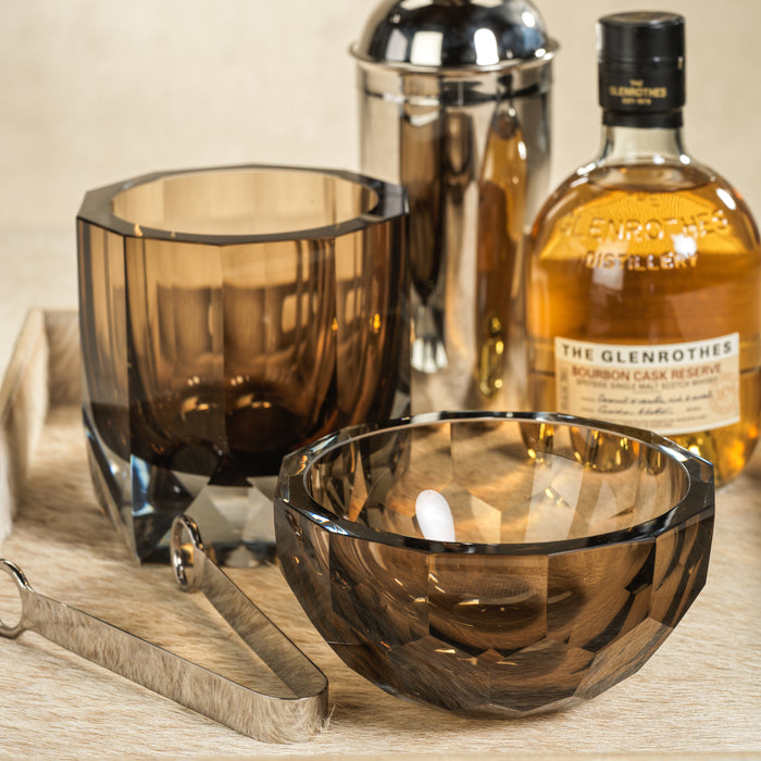 Glenrothes whiskey bottle with glassware on a wooden surface