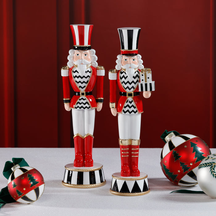 Two decorative nutcrackers with festive attire on a white surface against a red curtain background.