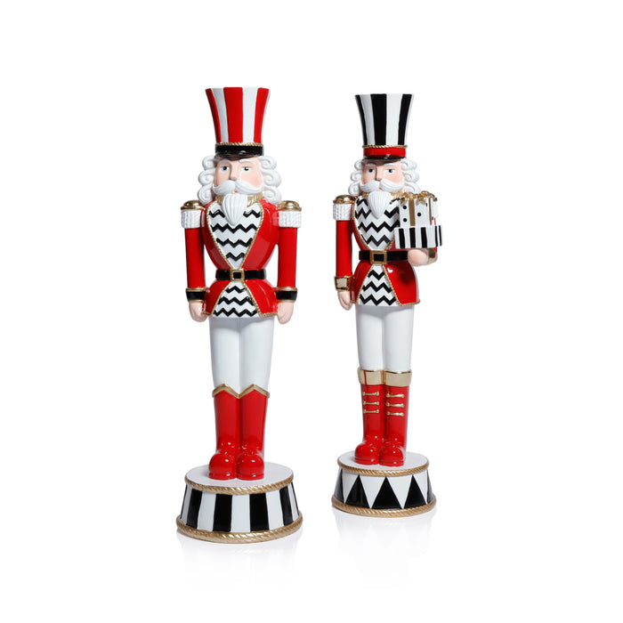 Two decorative nutcrackers with red, white, and black striped outfits on a white background.