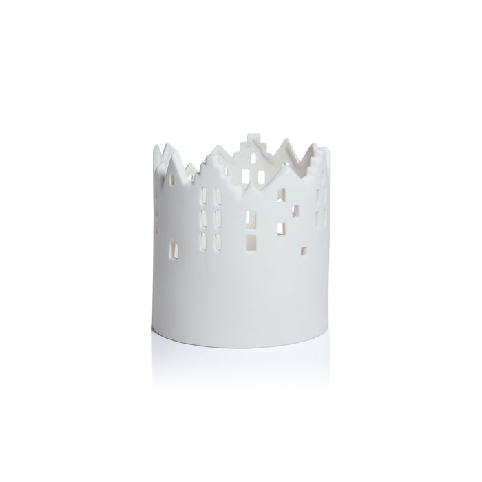 White metal candle holder with cut-out design on a white background