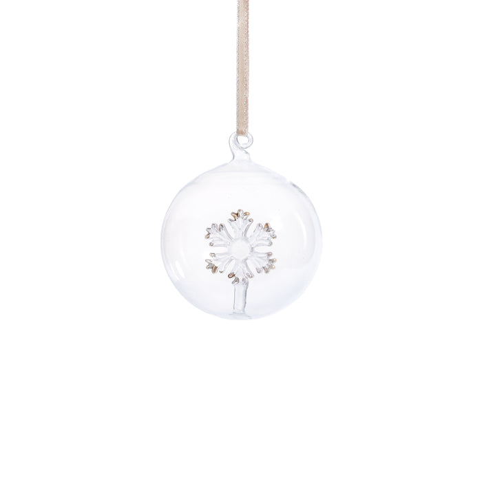 Clear glass ball ornament with snowflake design hanging on a white background