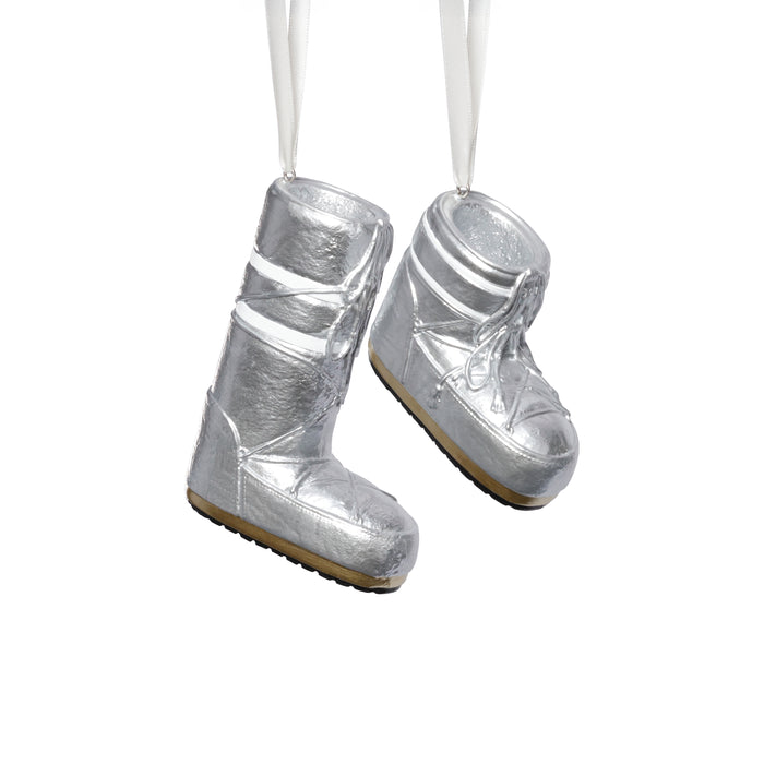 Silver boot ornaments on a white background