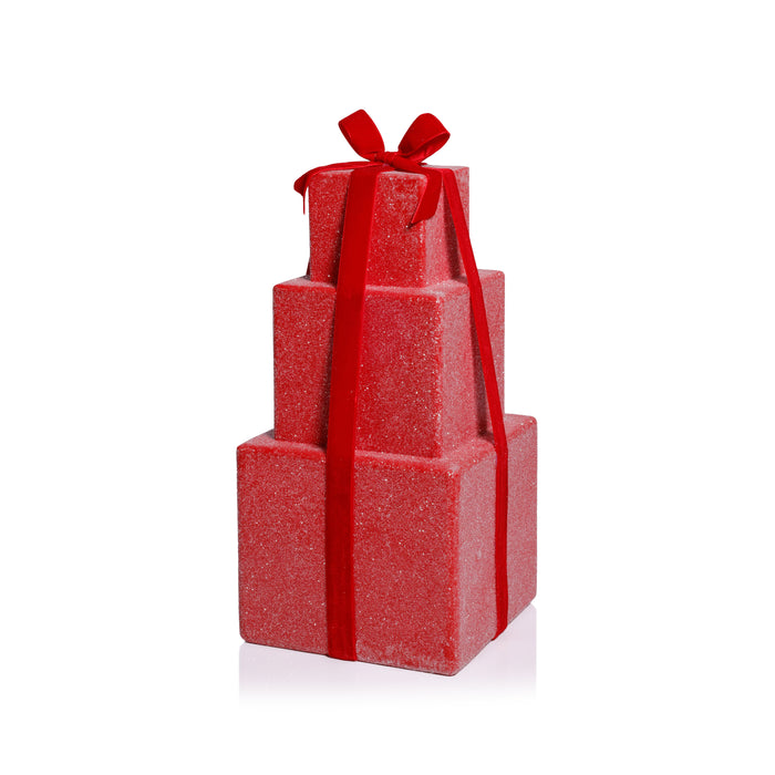 Stack of red gift boxes with a ribbon on a white background