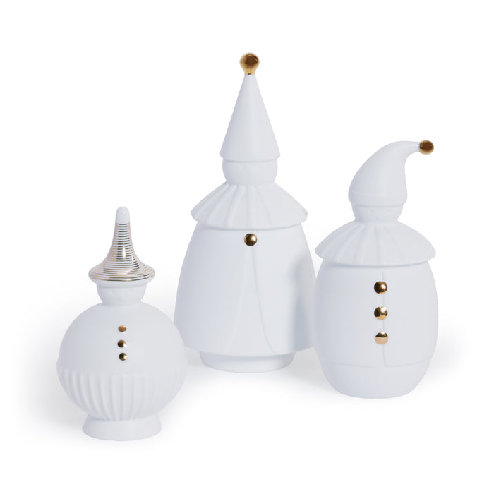 Set of three white ceramic jars with decorative lids on a white background