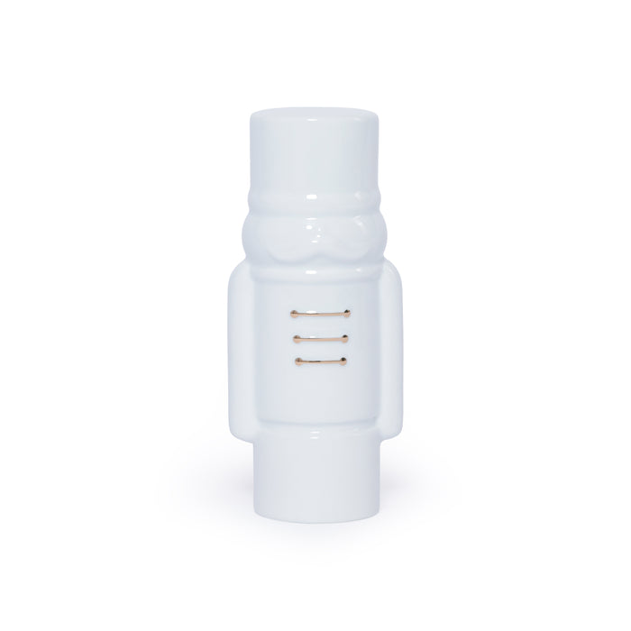 White cylindrical object with gold accents on a white background