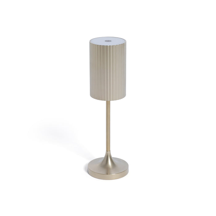 Table lamp with beige shade and metallic base on a white background