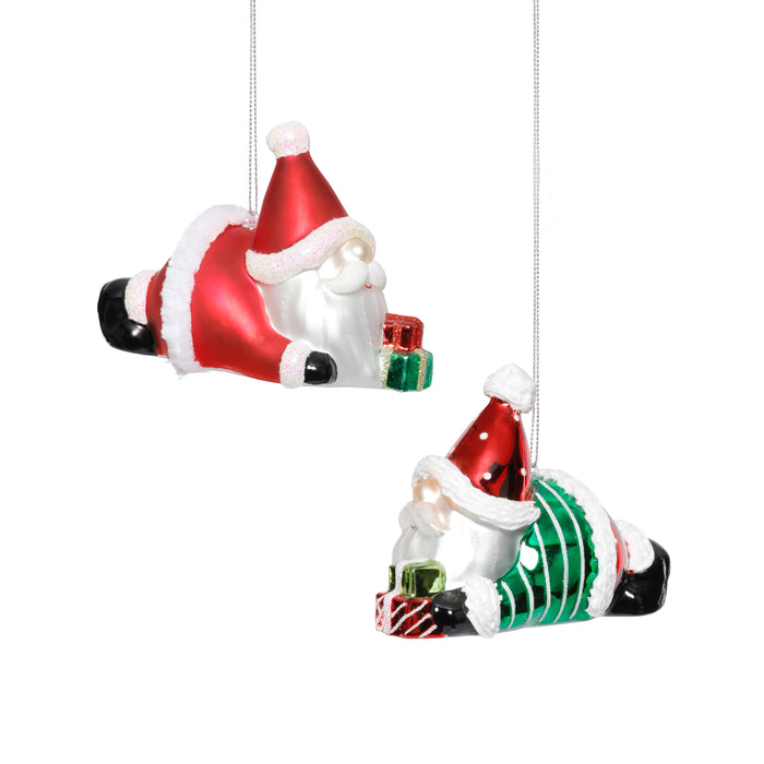 Two glass Christmas ornaments of a Santa Claus and an elf climbing a Christmas tree on a white background.