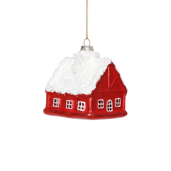 Red house-shaped Christmas ornament with white snow on a white background