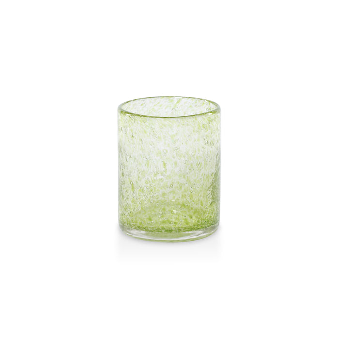 Green glass tumbler on a white background