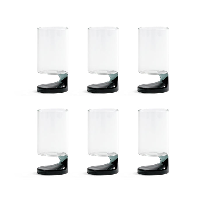 Set of six clear glasses with black bases on a white background