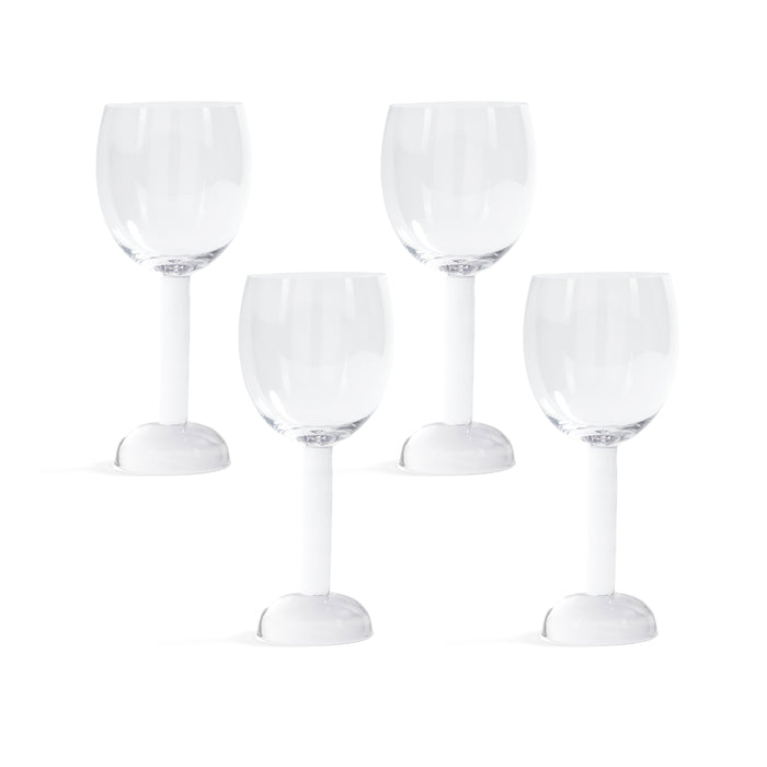 Set of four clear wine glasses on a white background