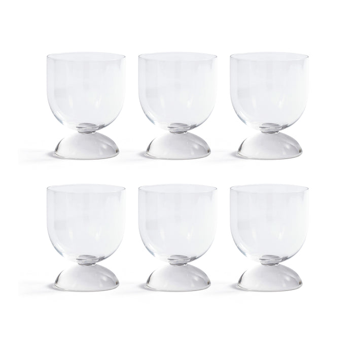 Set of six clear glass goblets on a white background