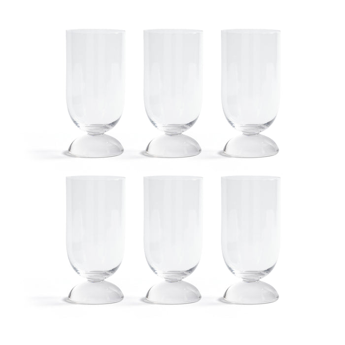 Set of six clear glass goblets on a white background