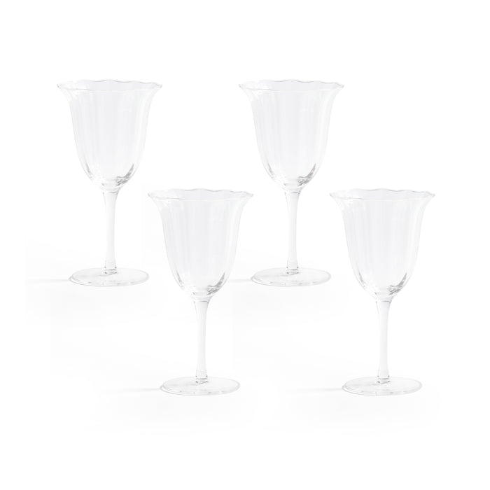 Set of four clear wine glasses on a white background