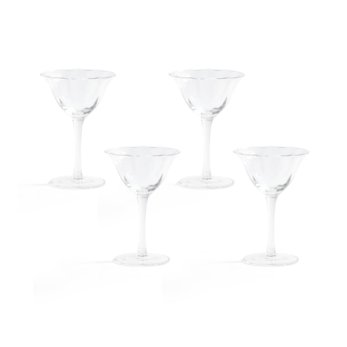 Set of four clear martini glasses on a white background